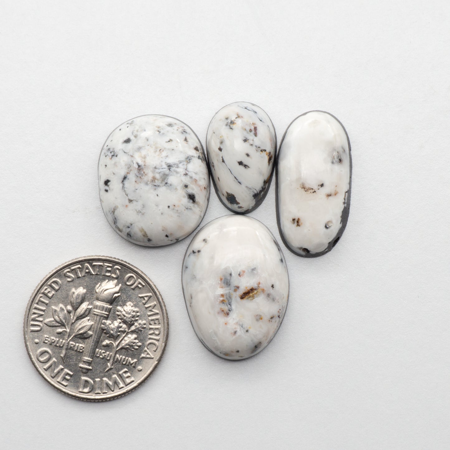 White Buffalo Stone Cabochons are semi-precious gemstones cut into shapes ideal for jewelry-making and crafting. The unique and varied veining of each cabochon lend an unparalleled depth and detail to any project, making them an excellent choice for artisans looking to add an individualistic touch.