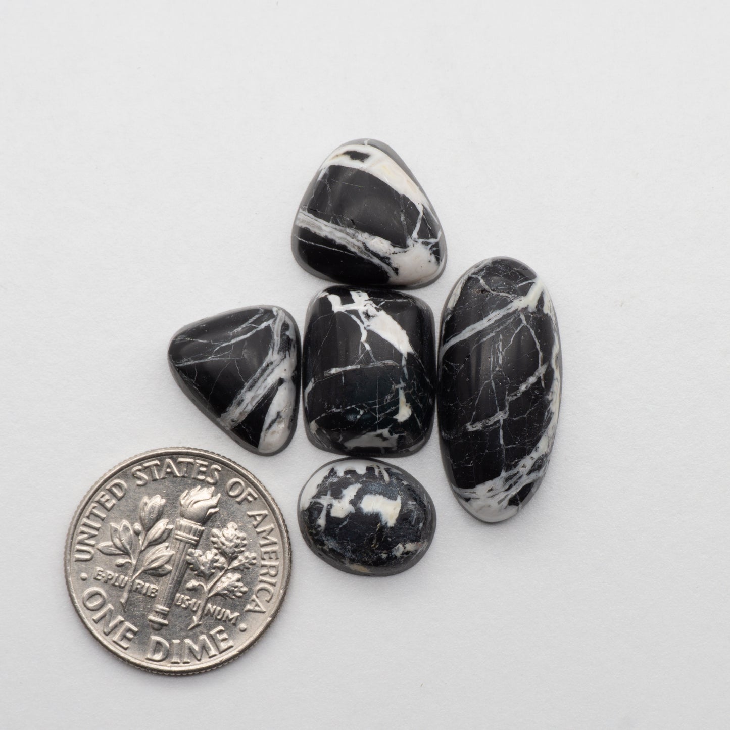 White Buffalo Stone Cabochons are semi-precious gemstones cut into shapes ideal for jewelry-making and crafting. The unique and varied veining of each cabochon lend an unparalleled depth and detail to any project, making them an excellent choice for artisans looking to add an individualistic touch.
