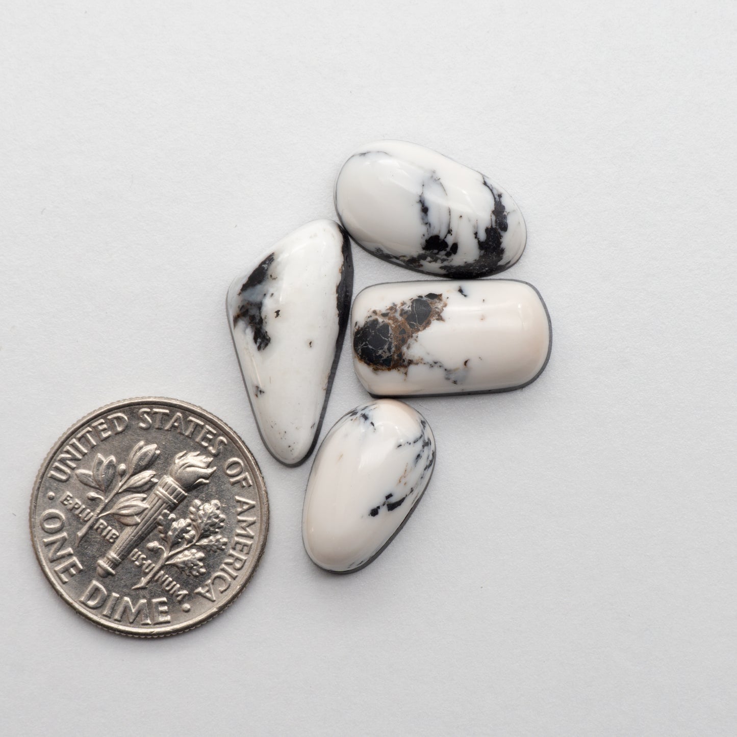 White Buffalo Stone Cabochons are semi-precious gemstones cut into shapes ideal for jewelry-making and crafting. The unique and varied veining of each cabochon lend an unparalleled depth and detail to any project, making them an excellent choice for artisans looking to add an individualistic touch.