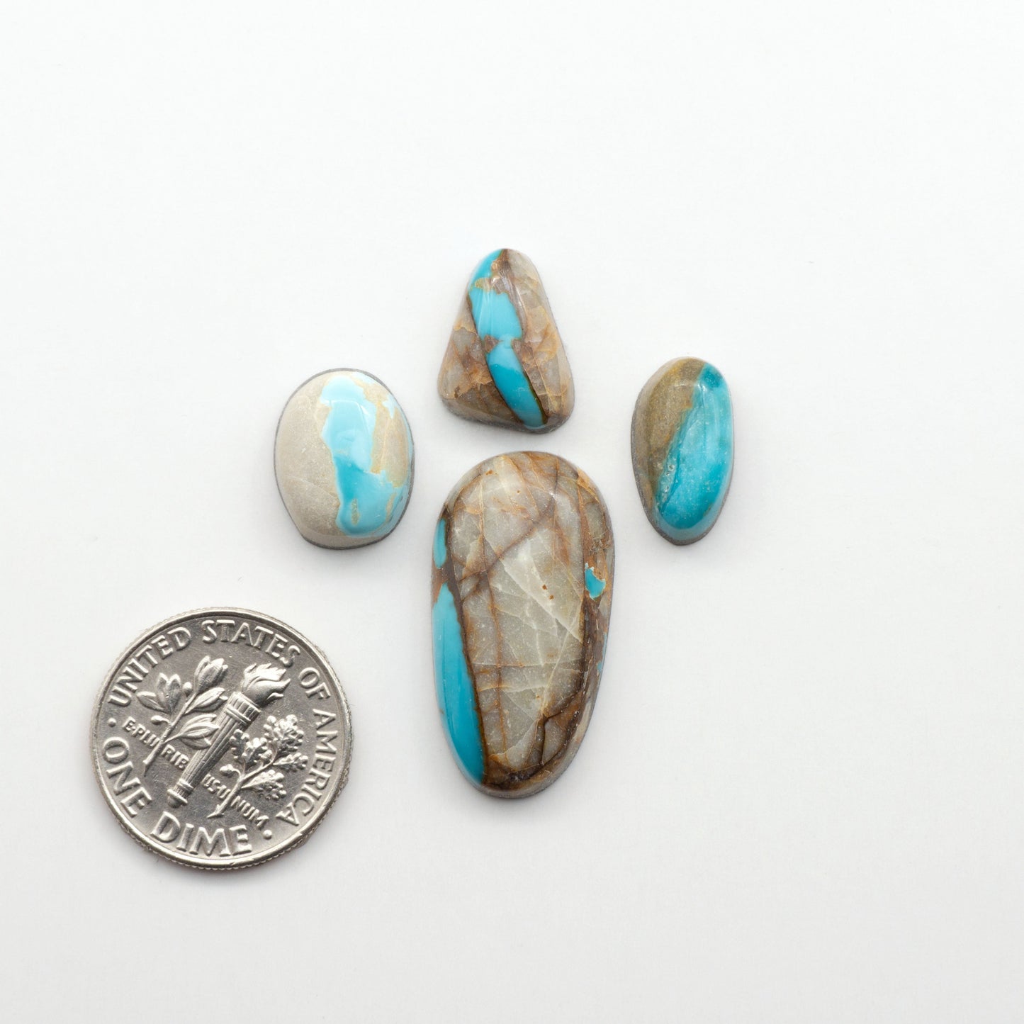 Royston Turquoise cabochons are famous for their distinctive matrix and unique green and blue hues, making them a favored option among jewelry designers.