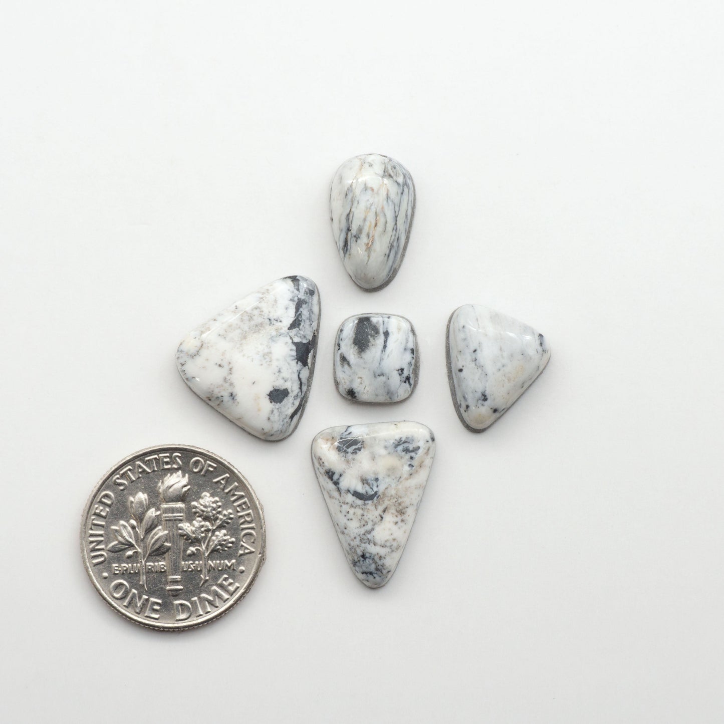 Natural White Buffalo Stone Cabochons are semi-precious gemstones cut into shapes ideal for jewelry-making, making them an excellent choice for artisans.