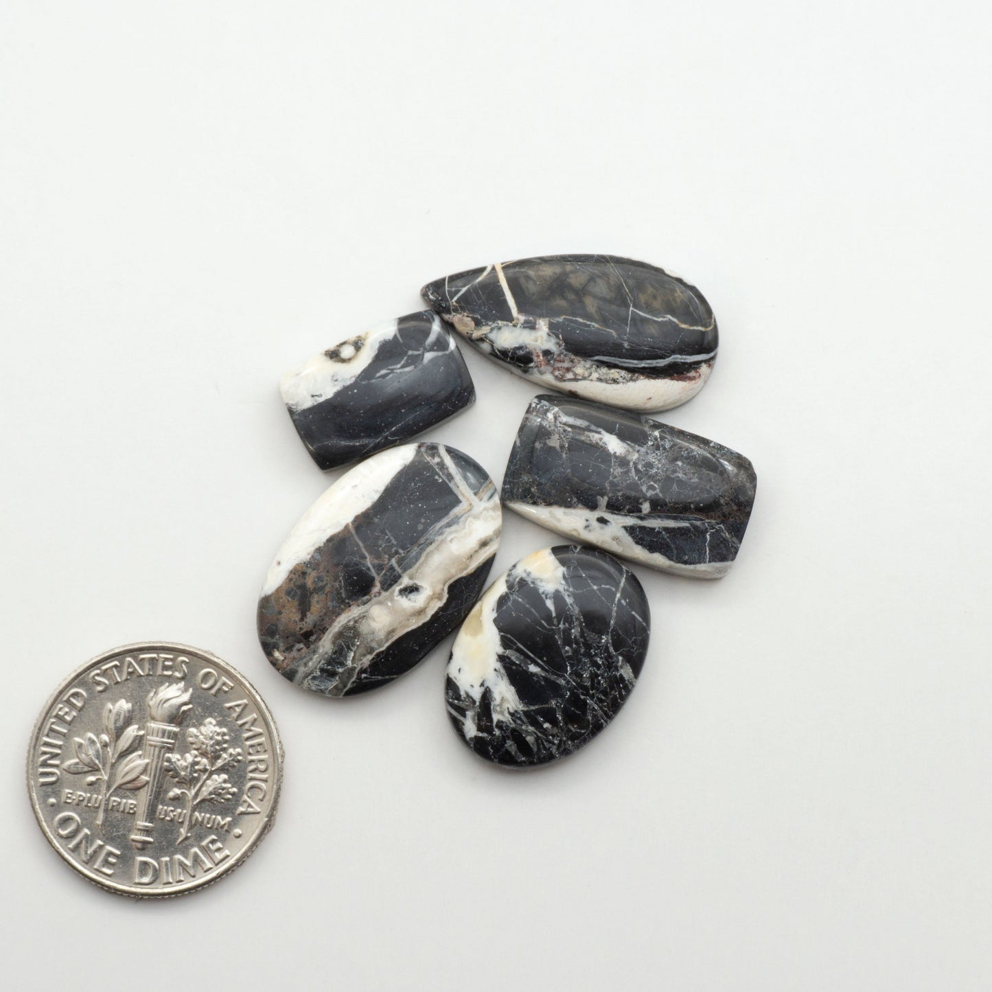 Natural White Buffalo Stone Cabochons are semi-precious gemstones cut into shapes ideal for jewelry-making, making them an excellent choice for artisans.