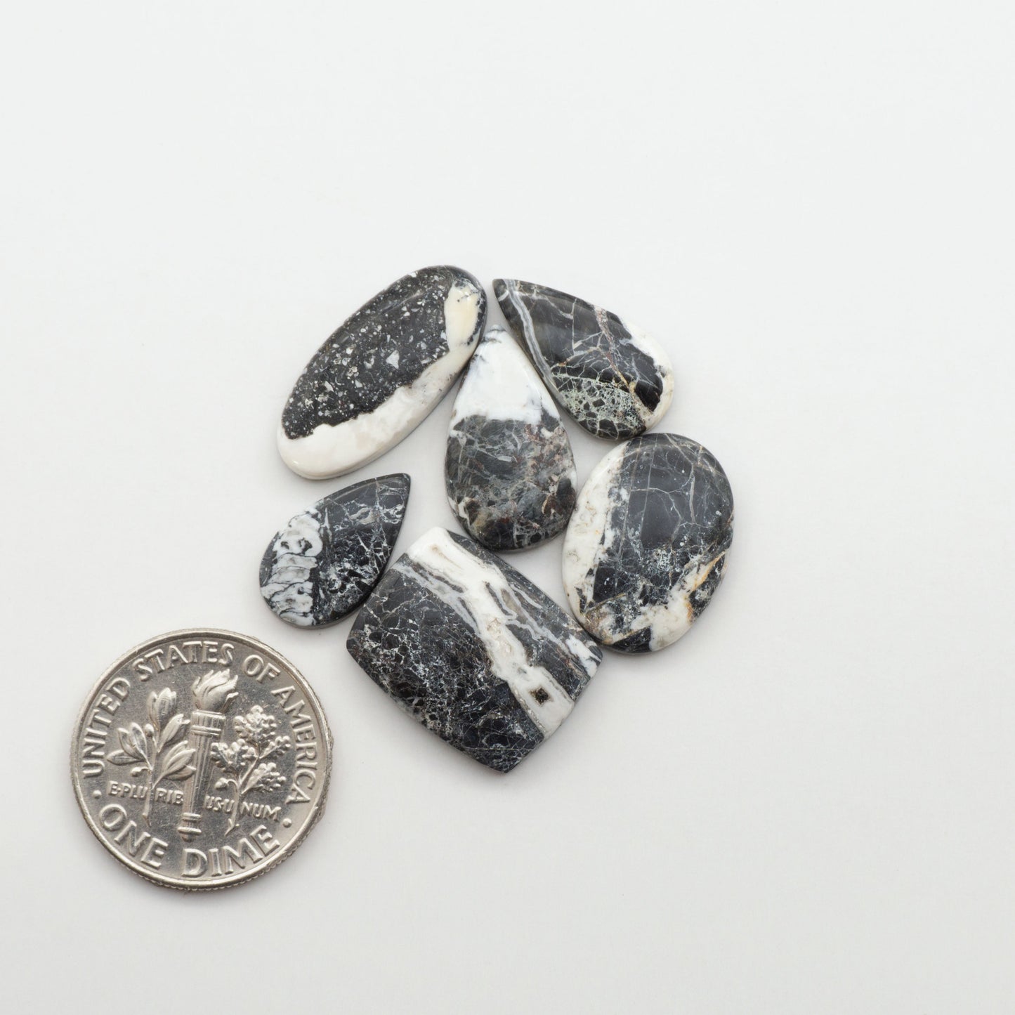 Natural White Buffalo Stone Cabochons are semi-precious gemstones cut into shapes ideal for jewelry-making, making them an excellent choice for artisans.