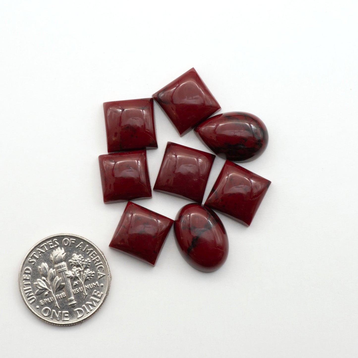 Bloody Bison Jasper is a composite stone with a vibrant red hue and black matrix that creates a strong impression and a touch of opulence to any jewelry piece.