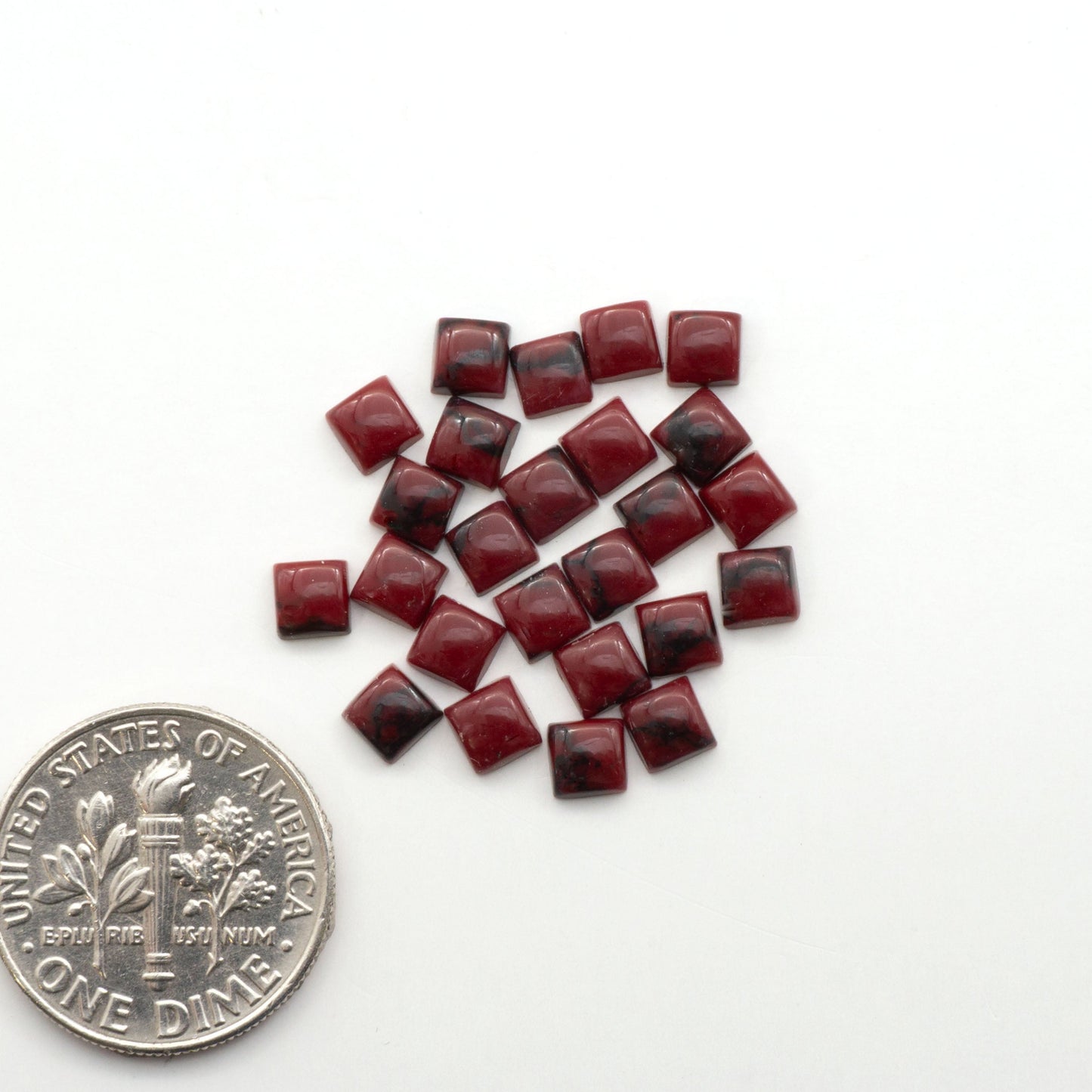 Bloody Bison Jasper is a composite stone with a vibrant red hue and black matrix that creates a strong impression and a touch of opulence to any jewelry piece.