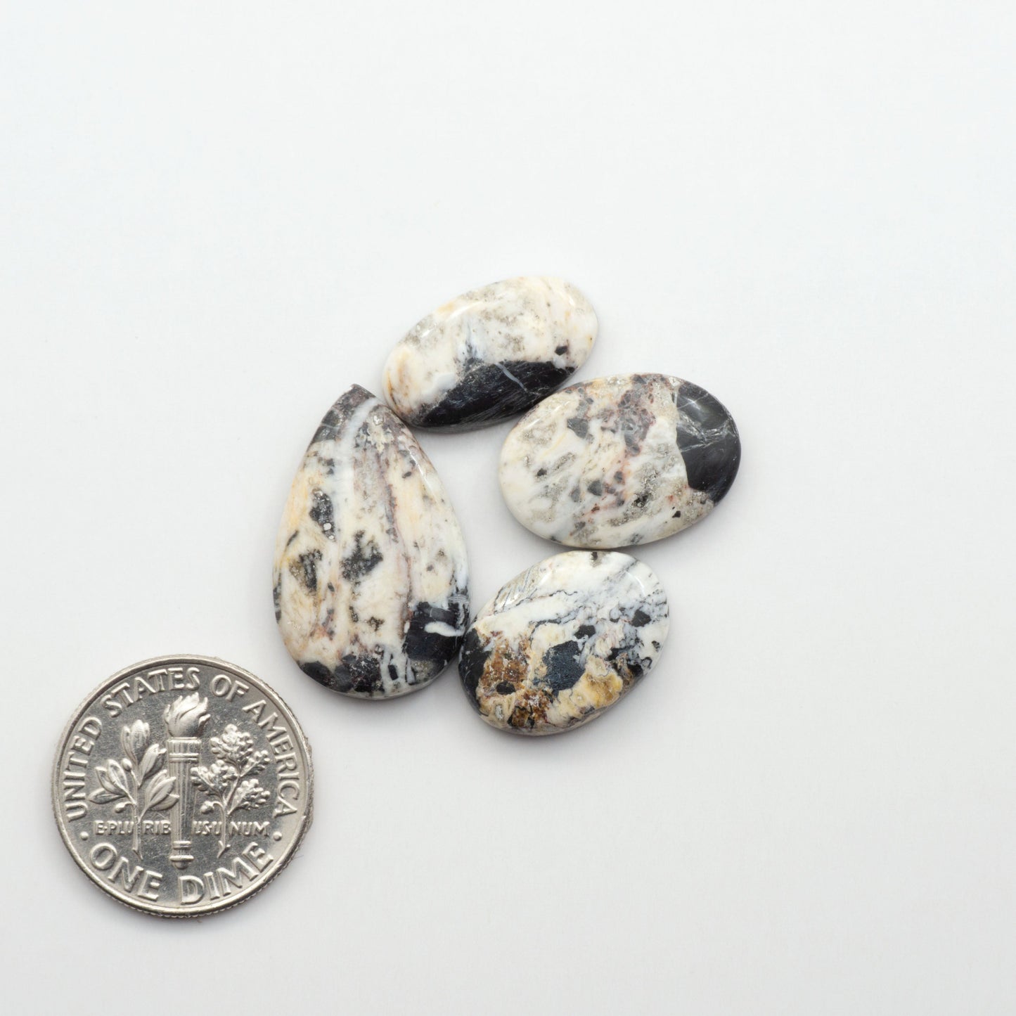 Natural White Buffalo Stone Cabochons are semi-precious gemstones cut into shapes ideal for jewelry-making, making them an excellent choice for artisans.