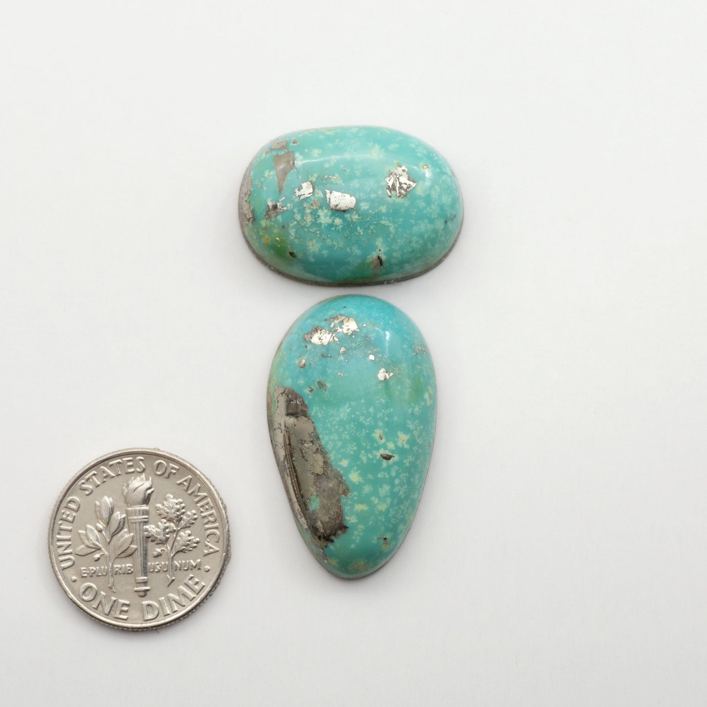 Nacozari turquoise cabochons are striking gemstones known for their vibrant blue to greenish-blue colors and pyrite, these stones are prized in jewelry making.