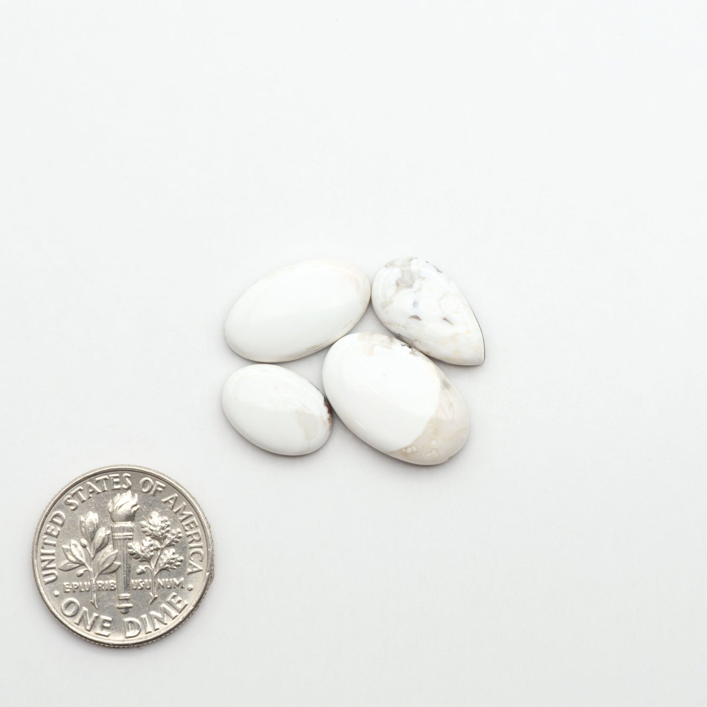 Natural White Buffalo Stone Cabochons are semi-precious gemstones cut into shapes ideal for jewelry-making, making them an excellent choice for artisans.