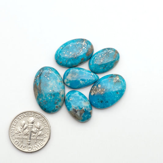 Nacozari turquoise cabochons are striking gemstones known for their vibrant blue to greenish-blue colors and pyrite, these stones are prized in jewelry making.