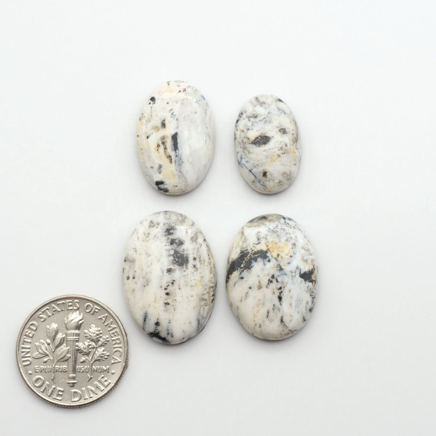Natural White Buffalo Stone Cabochons are semi-precious gemstones cut into shapes ideal for jewelry-making, making them an excellent choice for artisans.