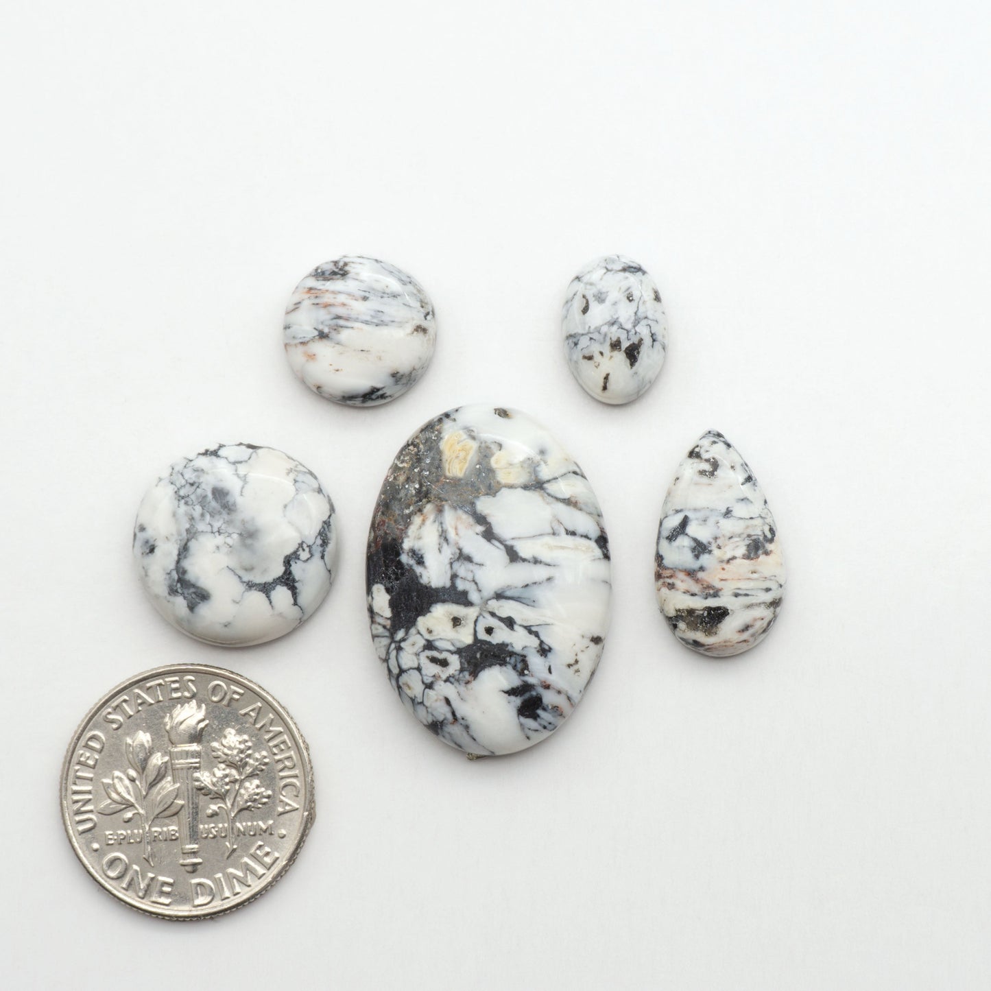 Natural White Buffalo Stone Cabochons are semi-precious gemstones cut into shapes ideal for jewelry-making, making them an excellent choice for artisans.