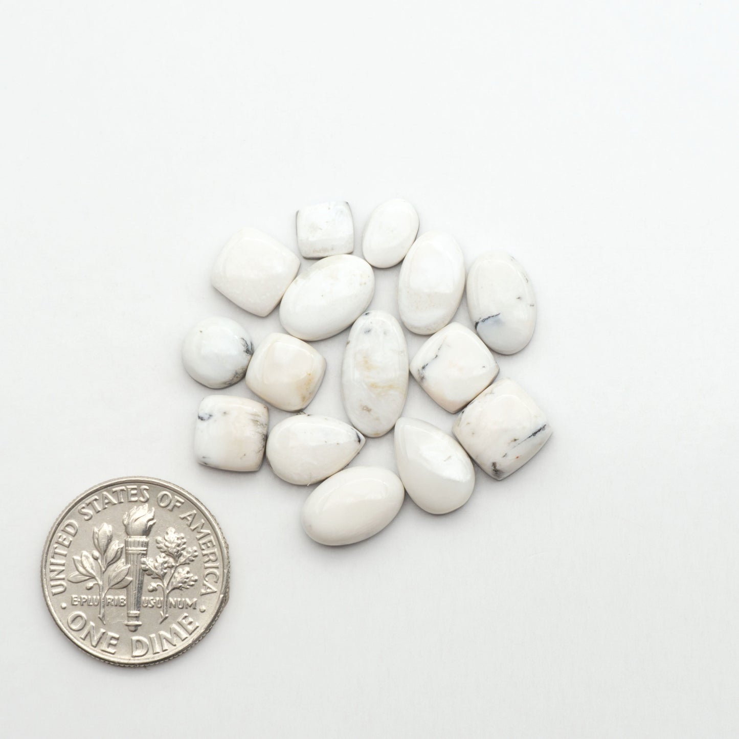 Natural White Buffalo Stone Cabochons are semi-precious gemstones cut into shapes ideal for jewelry-making, making them an excellent choice for artisans.