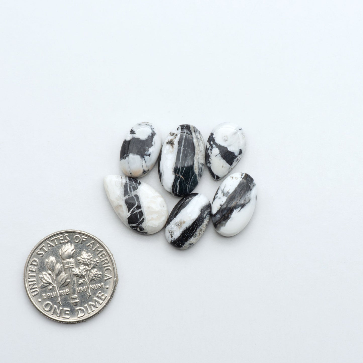 Natural White Buffalo Stone Cabochons are semi-precious gemstones cut into shapes ideal for jewelry-making, making them an excellent choice for artisans.