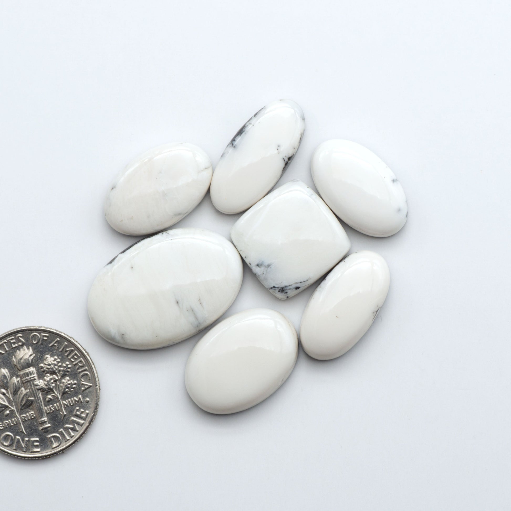 Natural White Buffalo Stone Cabochons are semi-precious gemstones cut into shapes ideal for jewelry-making, making them an excellent choice for artisans.