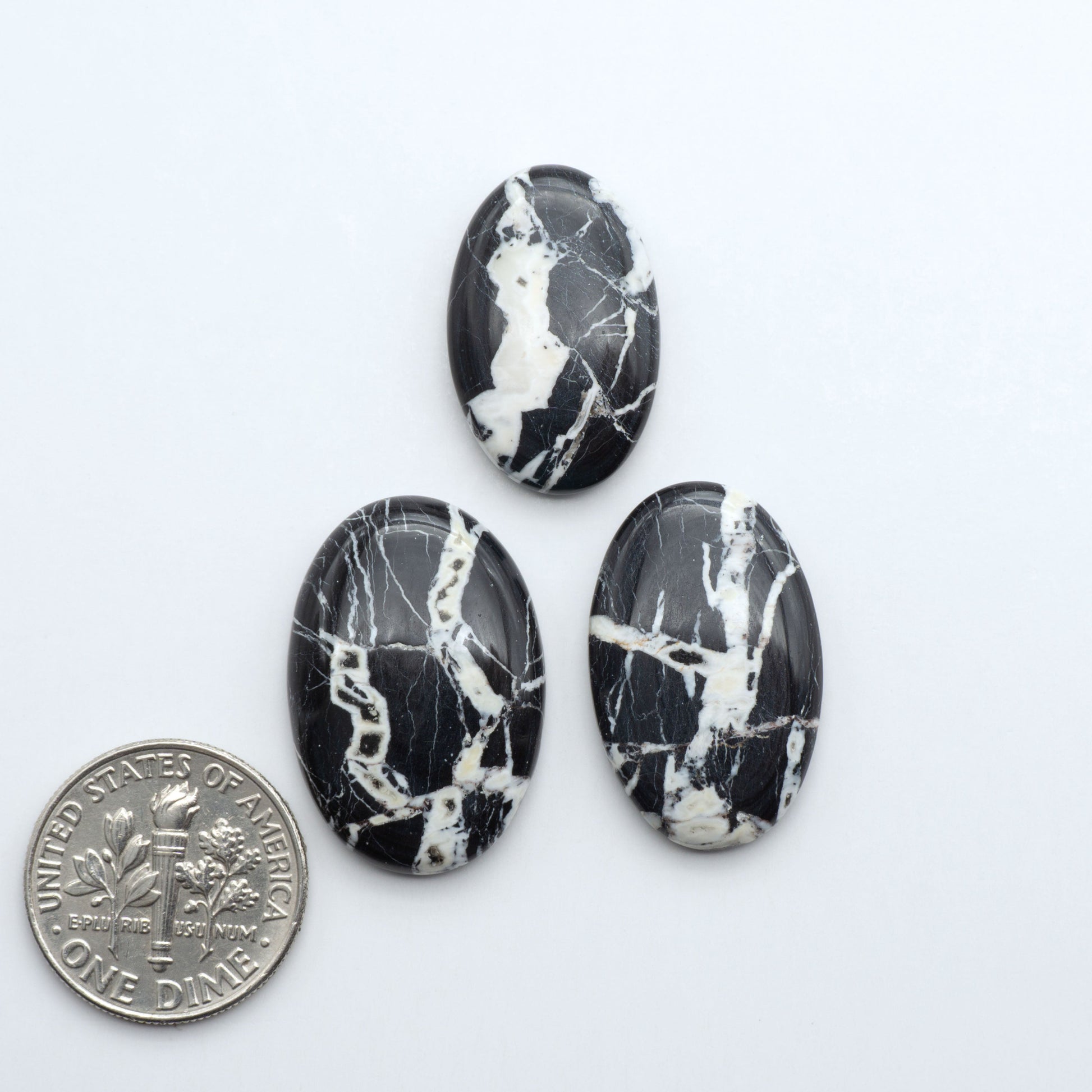 Natural White Buffalo Stone Cabochons are semi-precious gemstones cut into shapes ideal for jewelry-making, making them an excellent choice for artisans.