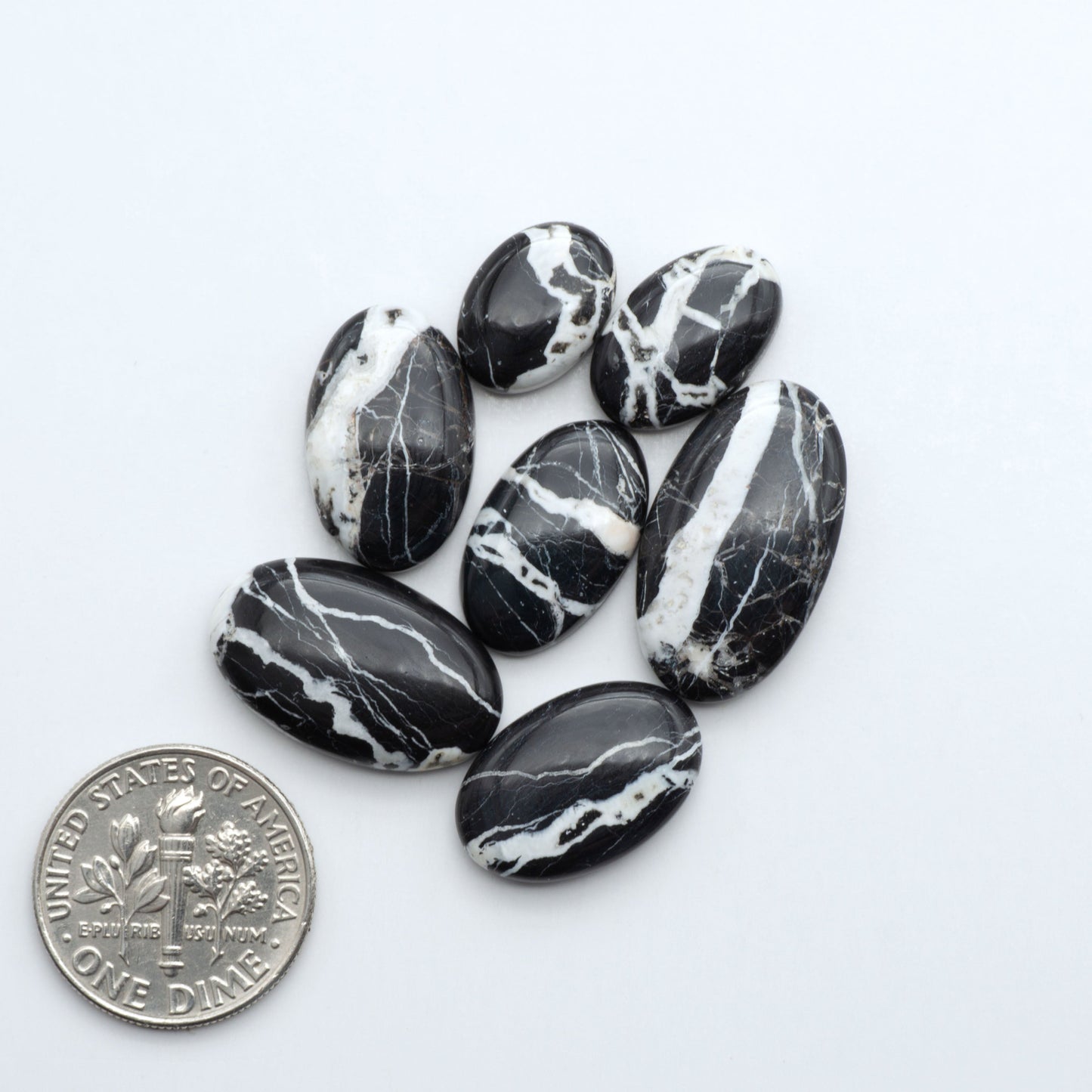 Natural White Buffalo Stone Cabochons are semi-precious gemstones cut into shapes ideal for jewelry-making, making them an excellent choice for artisans.