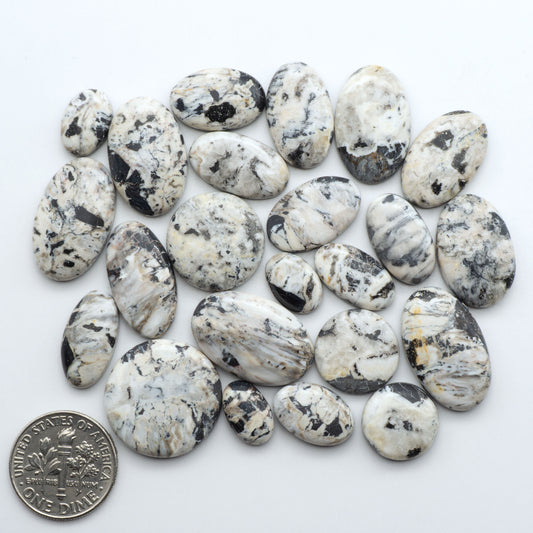 Natural White Buffalo Stone Cabochons are semi-precious gemstones cut into shapes ideal for jewelry-making, making them an excellent choice for artisans.