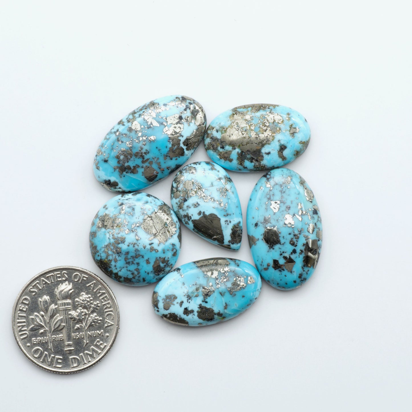 Nacozari turquoise cabochons are striking gemstones known for their vibrant blue to greenish-blue colors and pyrite, these stones are prized in jewelry making.