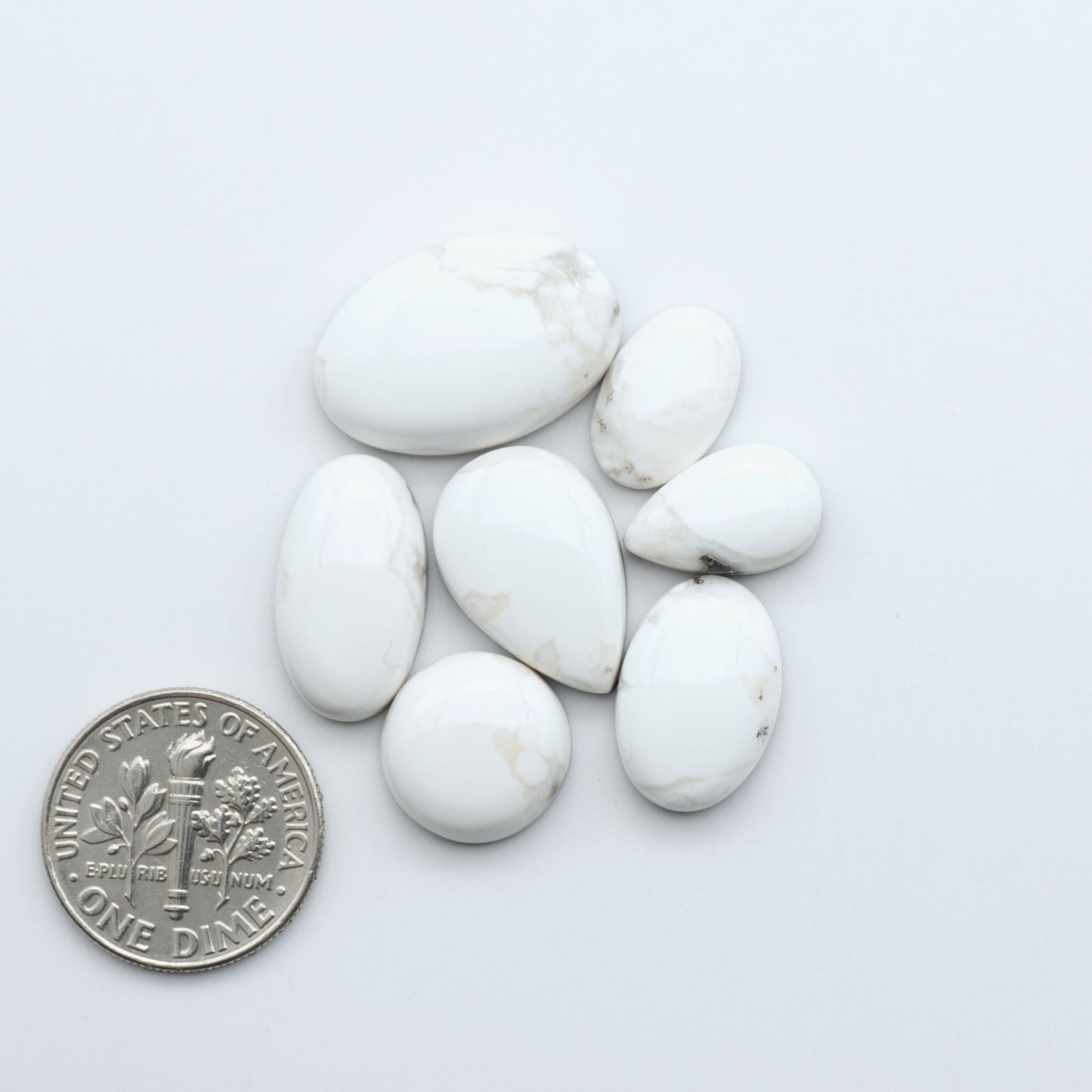 Natural White Buffalo Stone Cabochons are semi-precious gemstones cut into shapes ideal for jewelry-making, making them an excellent choice for artisans.