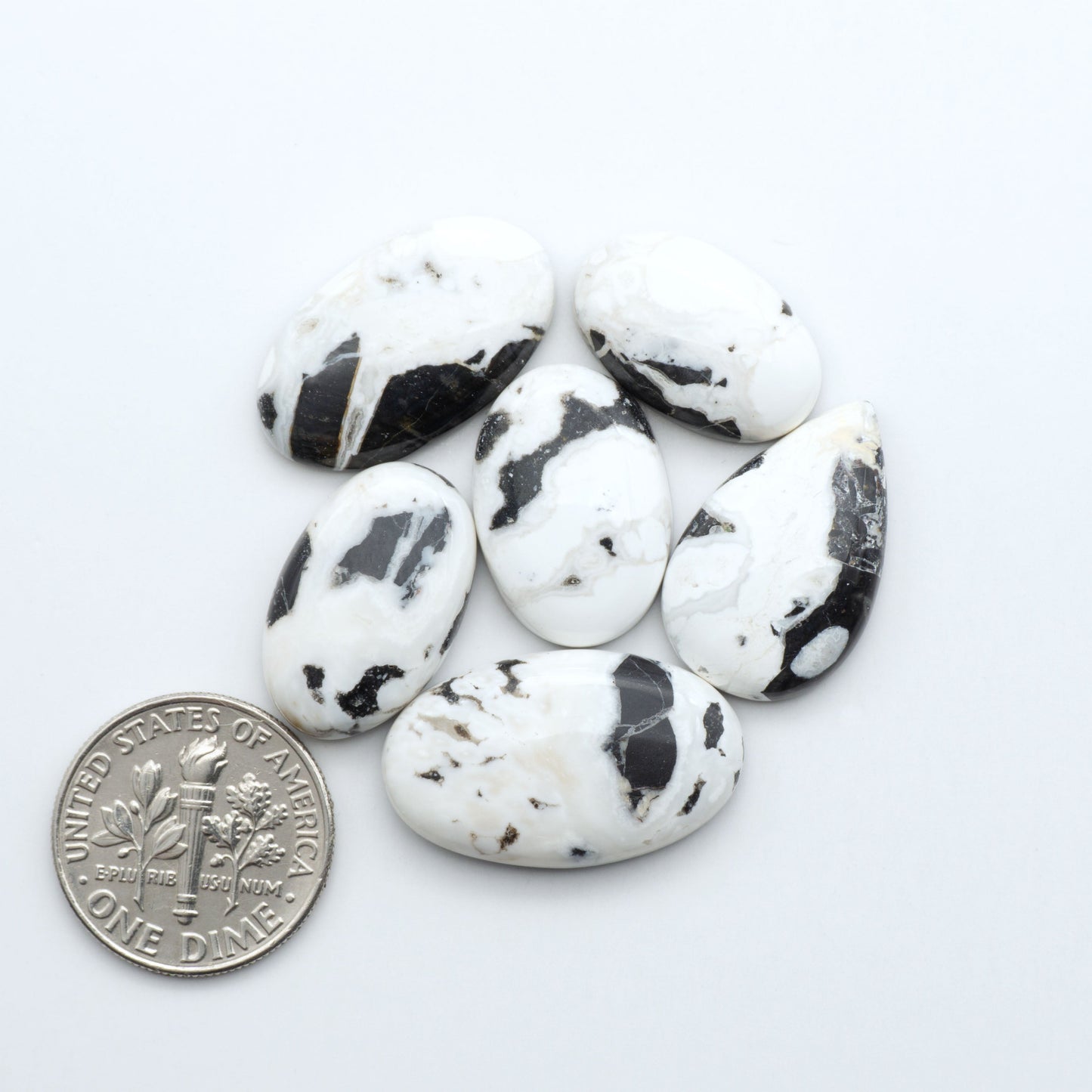 Natural White Buffalo Stone Cabochons are semi-precious gemstones cut into shapes ideal for jewelry-making, making them an excellent choice for artisans.