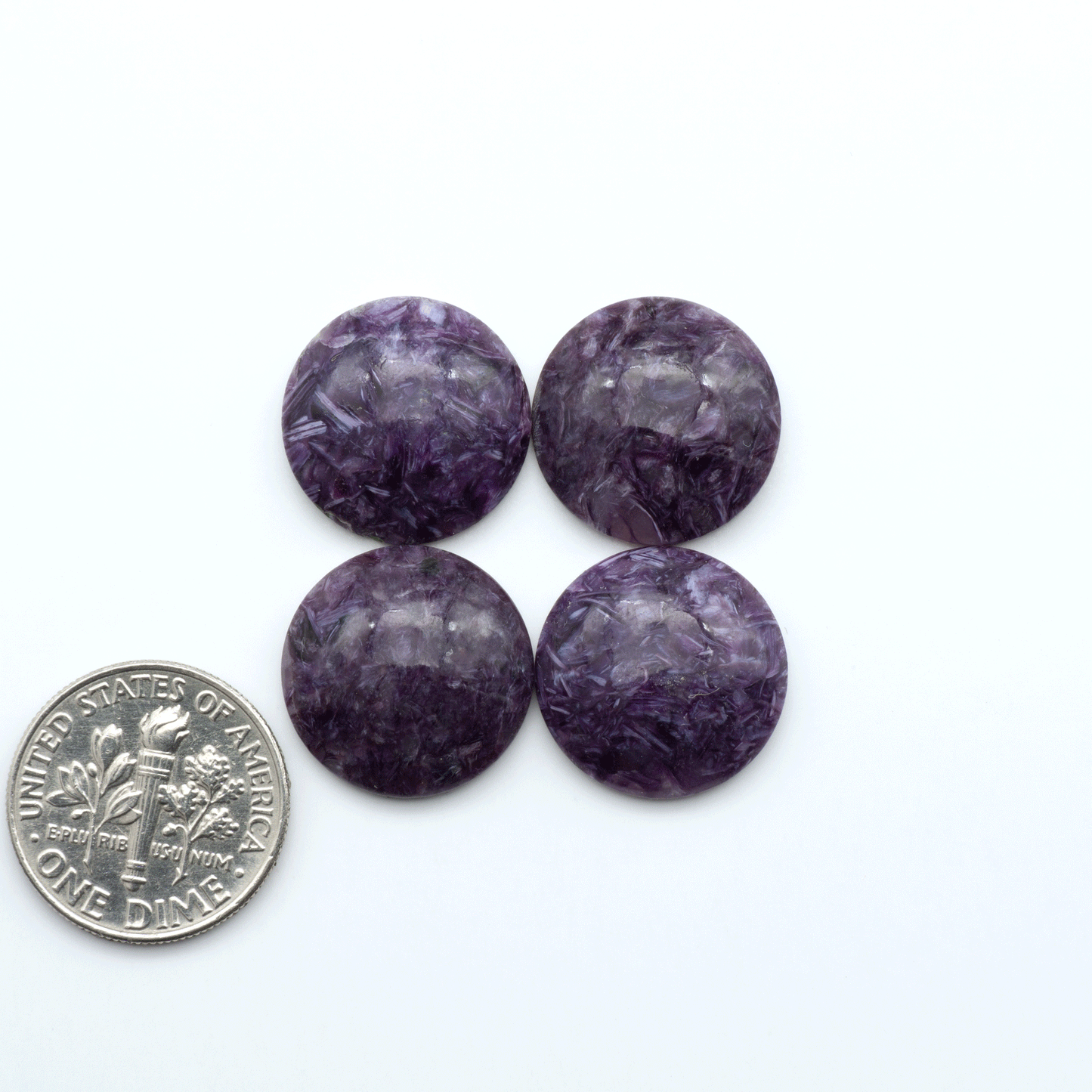 Shop natural Charoite cabochons with vivid violet swirls, perfect for jewelry makers and silversmiths creating rings, pendants, and custom designs.