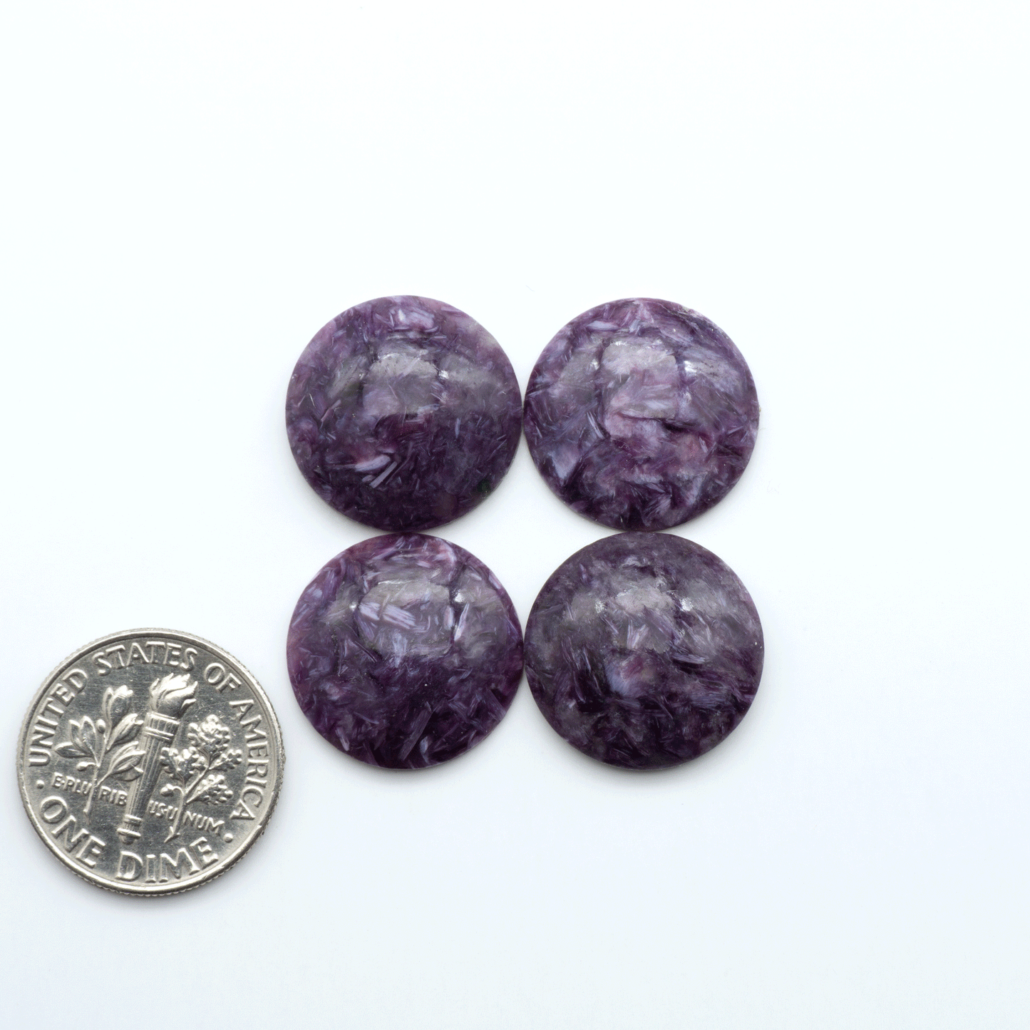 Shop natural Charoite cabochons with vivid violet swirls, perfect for jewelry makers and silversmiths creating rings, pendants, and custom designs.
