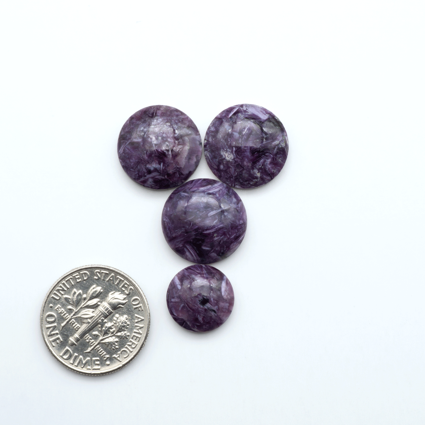 Shop natural Charoite cabochons with vivid violet swirls, perfect for jewelry makers and silversmiths creating rings, pendants, and custom designs.