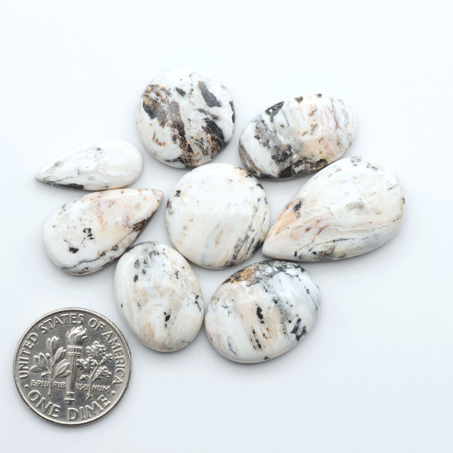 Natural White Buffalo Stone Cabochons are semi-precious gemstones cut into shapes ideal for jewelry-making, making them an excellent choice for artisans.