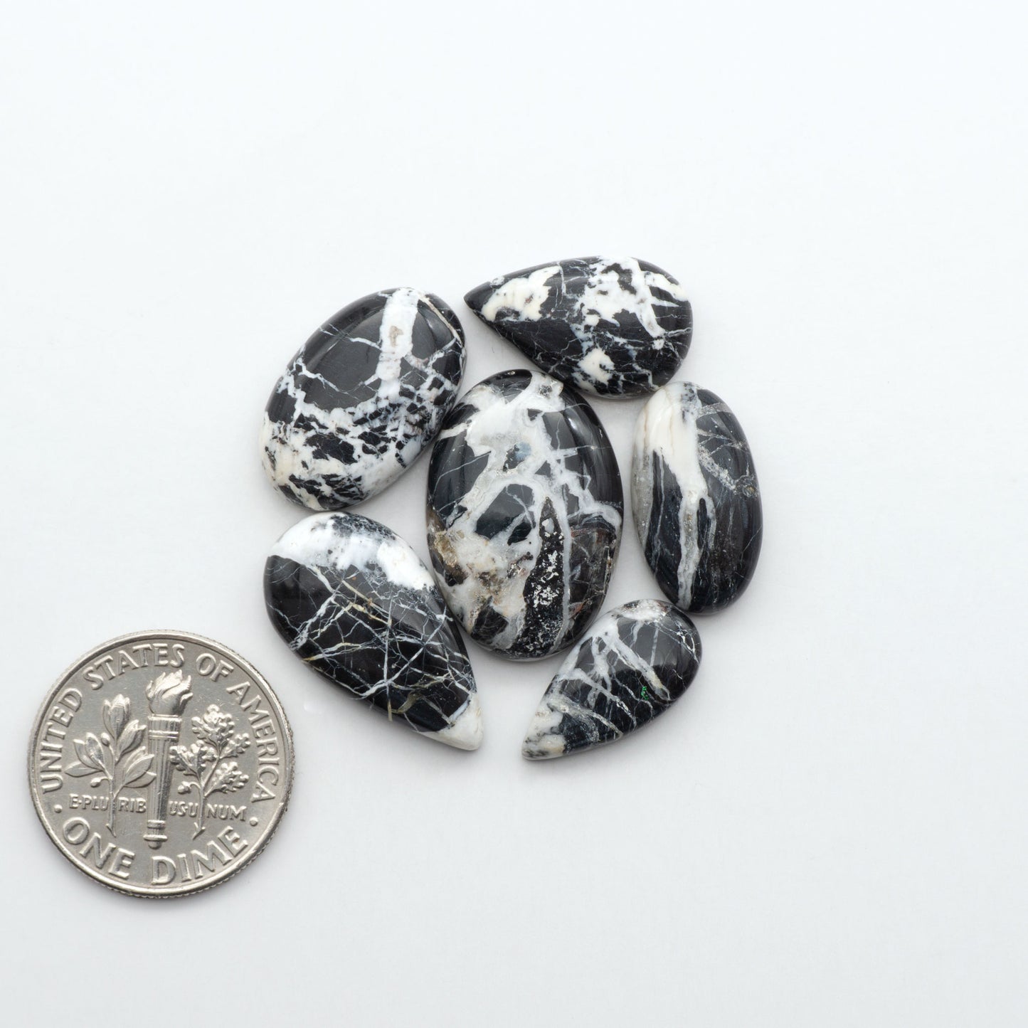 Natural White Buffalo Stone Cabochons are semi-precious gemstones cut into shapes ideal for jewelry-making, making them an excellent choice for artisans.
