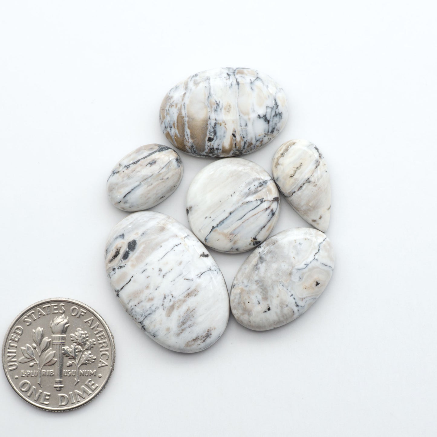 Natural White Buffalo Stone Cabochons are semi-precious gemstones cut into shapes ideal for jewelry-making, making them an excellent choice for artisans.