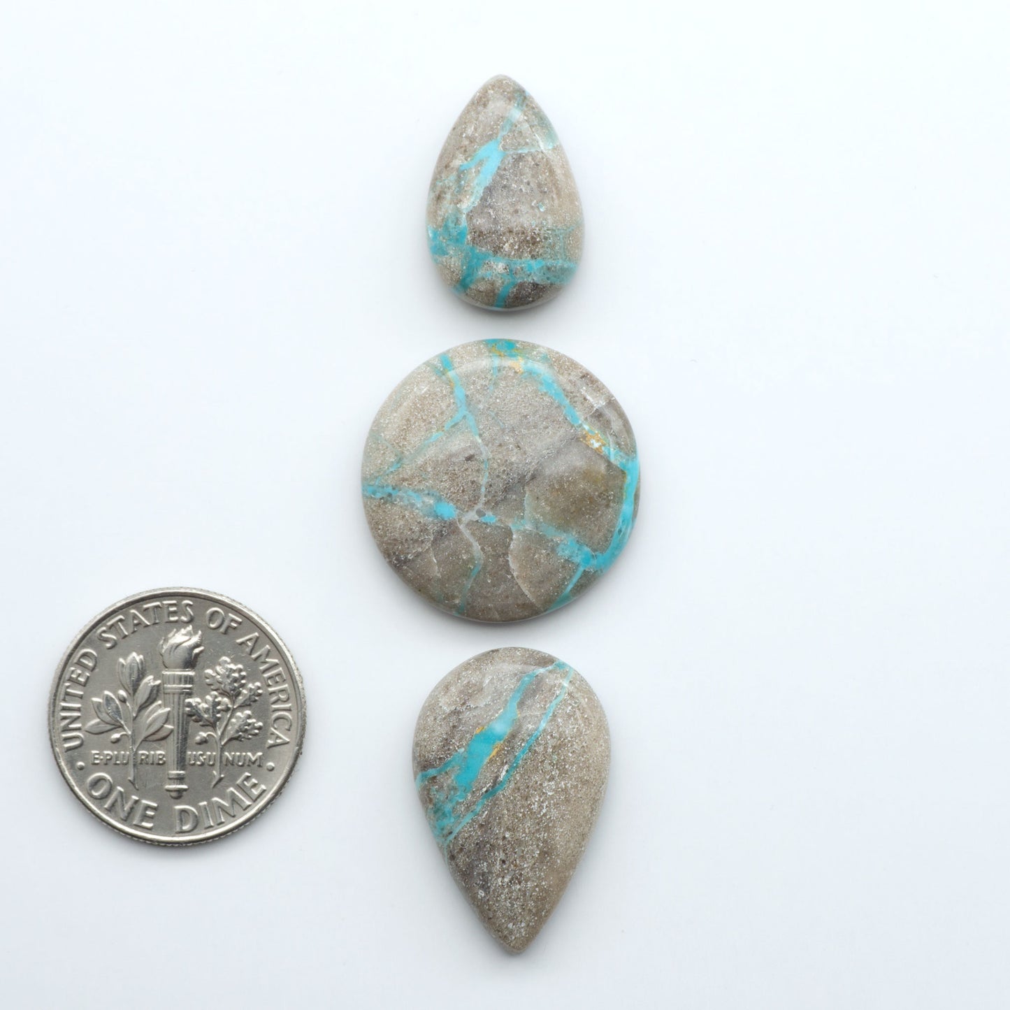 Carico Lake Turquoise cabochons with vibrant aqua-blue to turquoise tones and natural matrix, ideal for rings, pendants, and artisan jewelry.