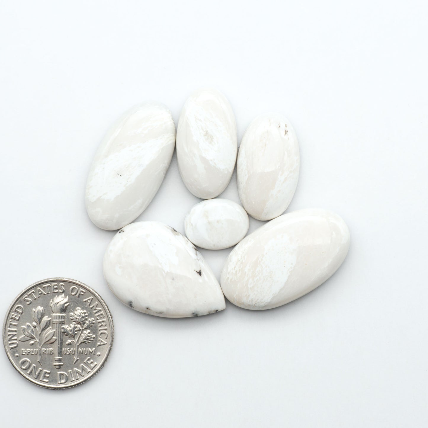 Natural White Buffalo Stone Cabochons are semi-precious gemstones cut into shapes ideal for jewelry-making, making them an excellent choice for artisans.