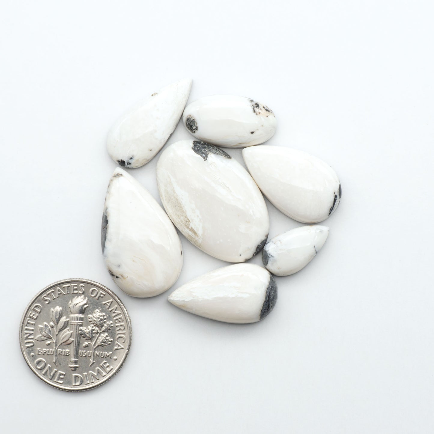 Natural White Buffalo Stone Cabochons are semi-precious gemstones cut into shapes ideal for jewelry-making, making them an excellent choice for artisans.