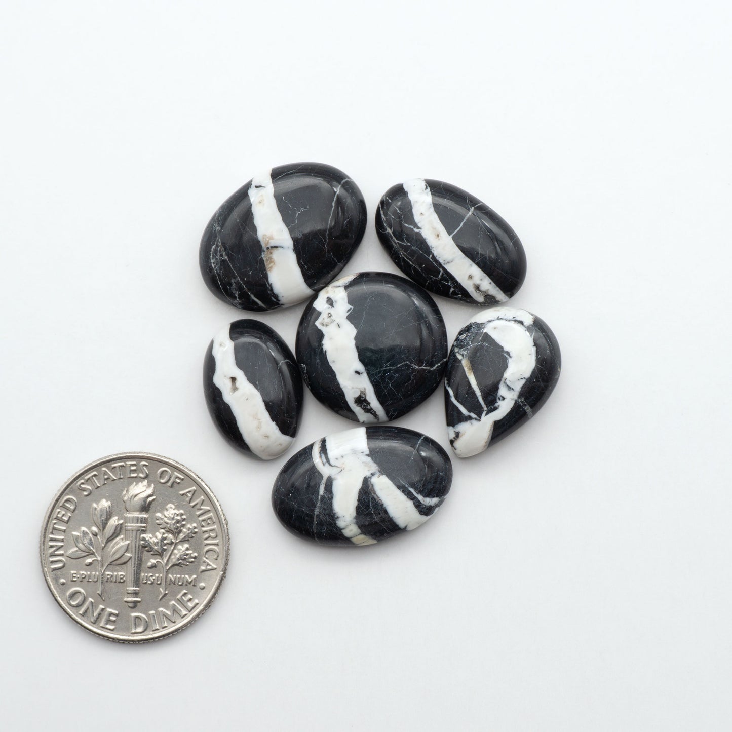 Natural White Buffalo Stone Cabochons are semi-precious gemstones cut into shapes ideal for jewelry-making, making them an excellent choice for artisans.