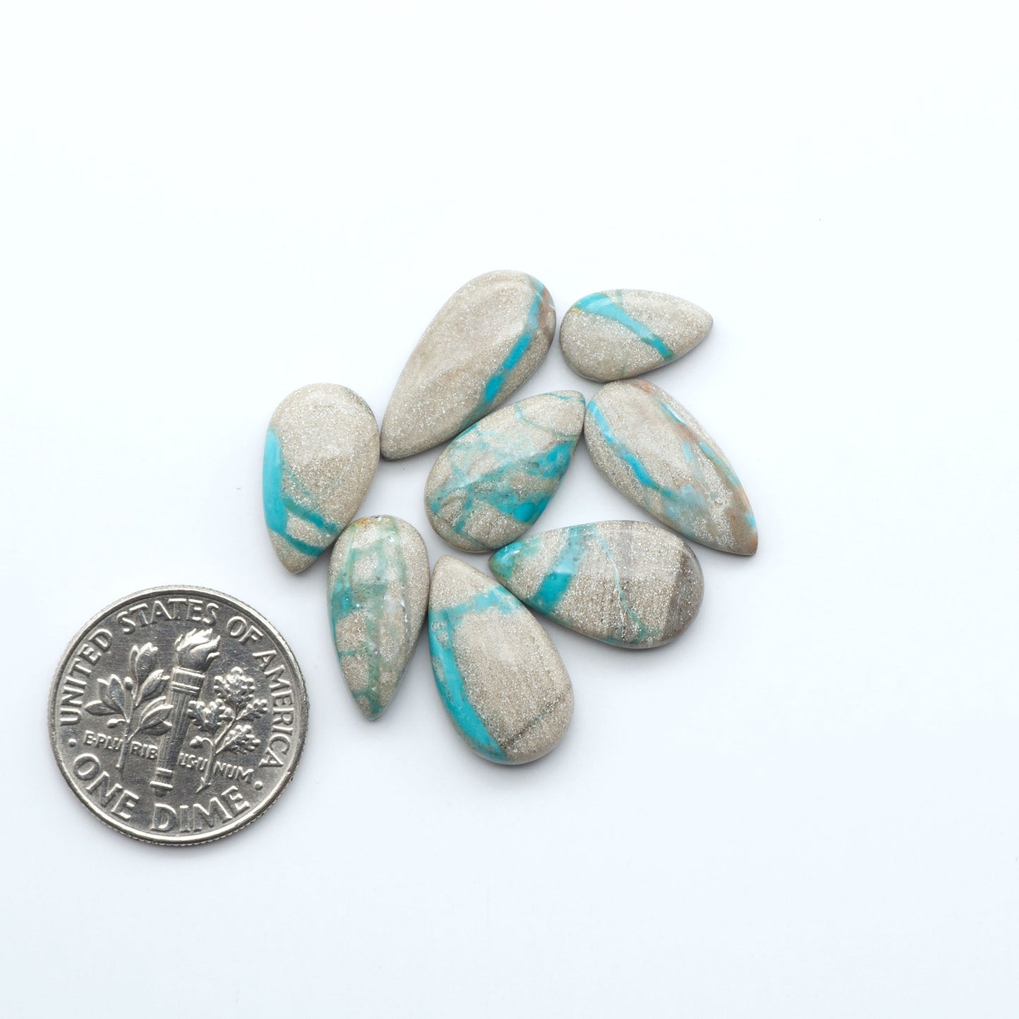 Carico Lake Turquoise cabochons with vibrant aqua-blue to turquoise tones and natural matrix, ideal for rings, pendants, and artisan jewelry.