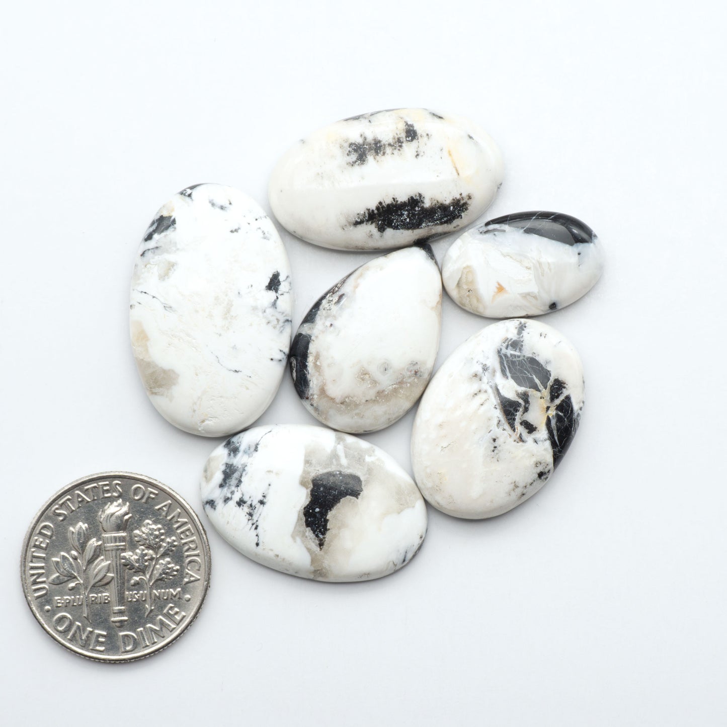 Natural White Buffalo Stone Cabochons are semi-precious gemstones cut into shapes ideal for jewelry-making, making them an excellent choice for artisans.