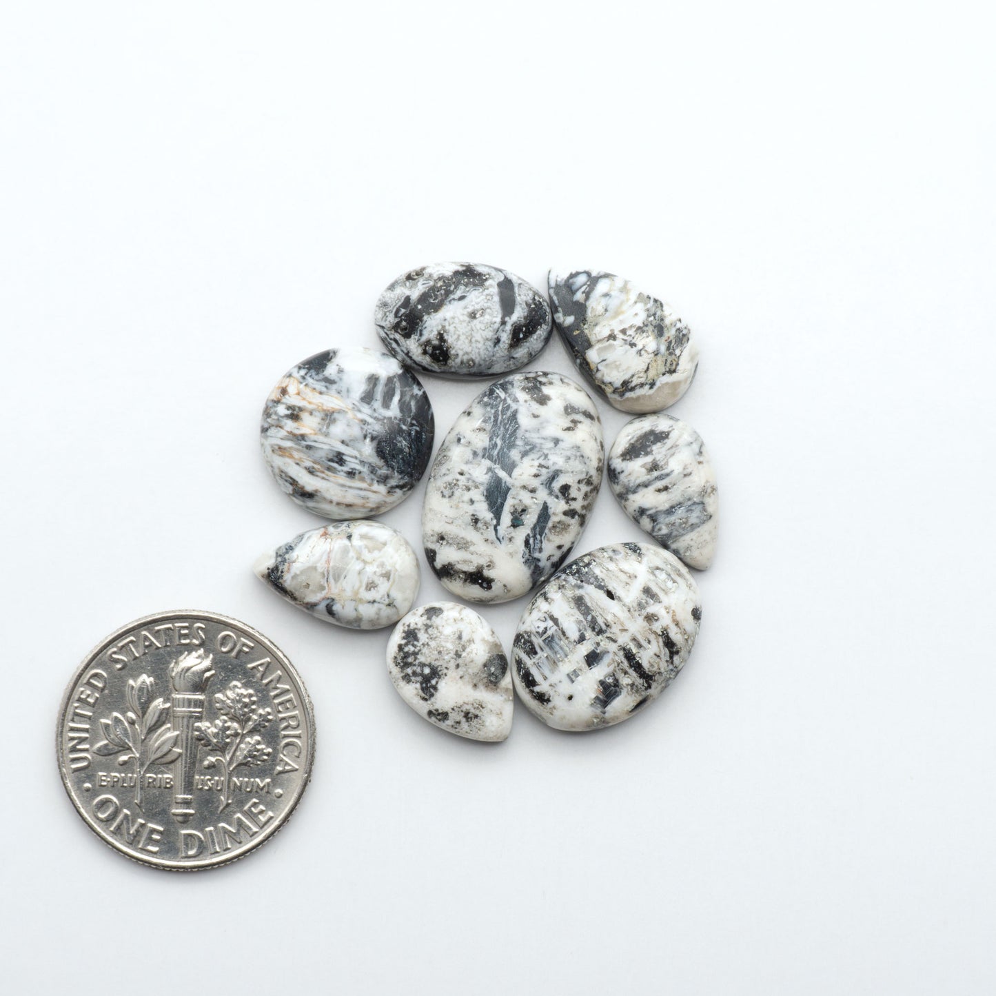 Natural White Buffalo Stone Cabochons are semi-precious gemstones cut into shapes ideal for jewelry-making, making them an excellent choice for artisans.