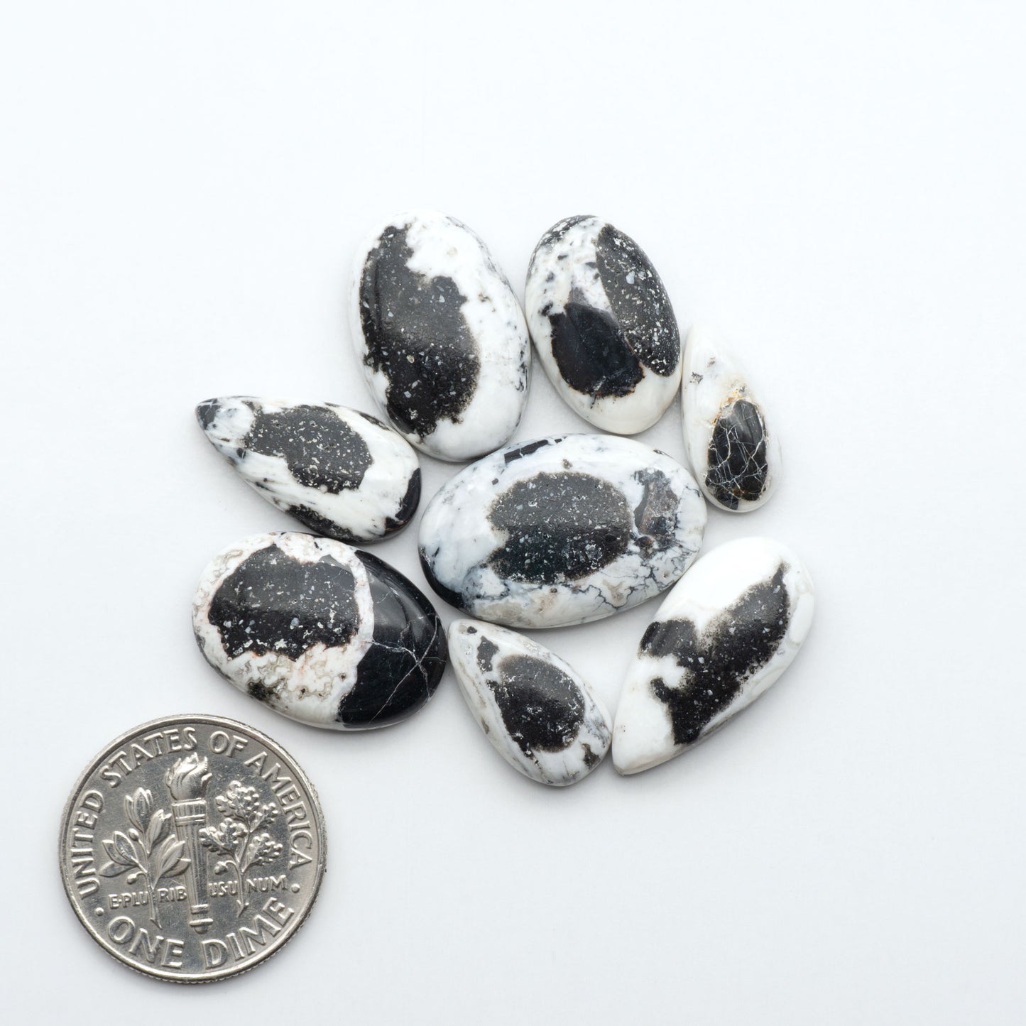 Natural White Buffalo Stone Cabochons are semi-precious gemstones cut into shapes ideal for jewelry-making, making them an excellent choice for artisans.