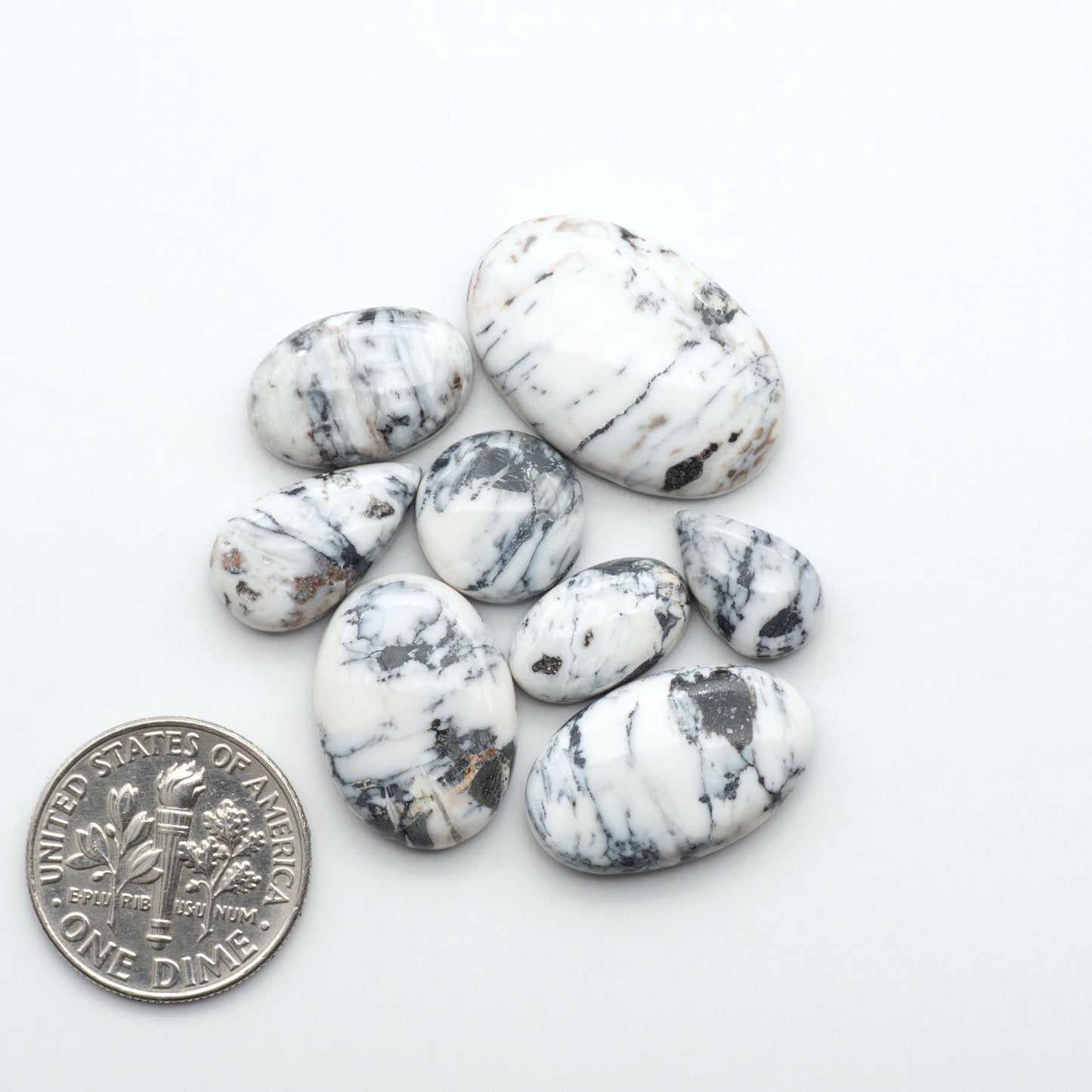 Natural White Buffalo Stone Cabochons are semi-precious gemstones cut into shapes ideal for jewelry-making, making them an excellent choice for artisans.