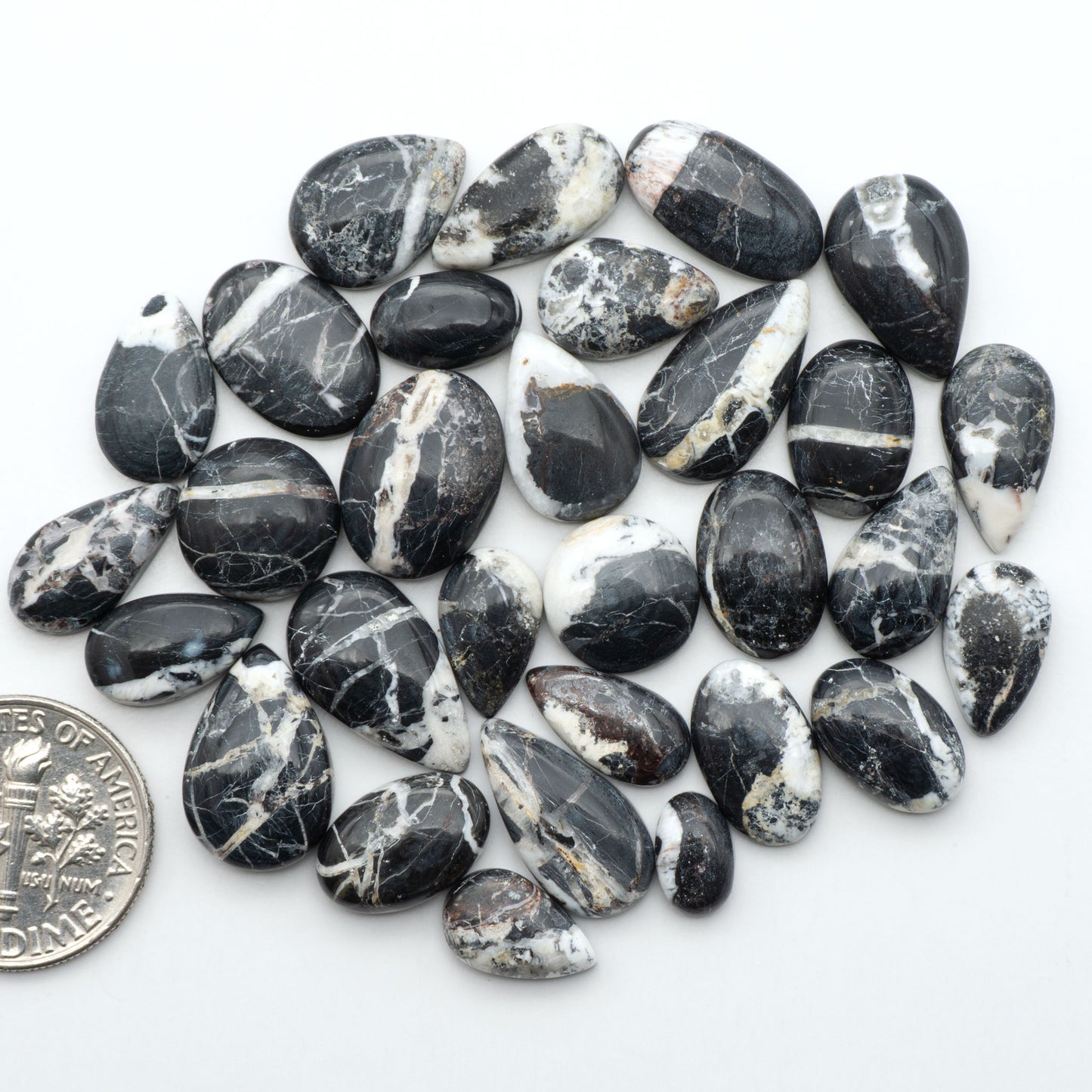 Natural White Buffalo Stone Cabochons are semi-precious gemstones cut into shapes ideal for jewelry-making, making them an excellent choice for artisans.