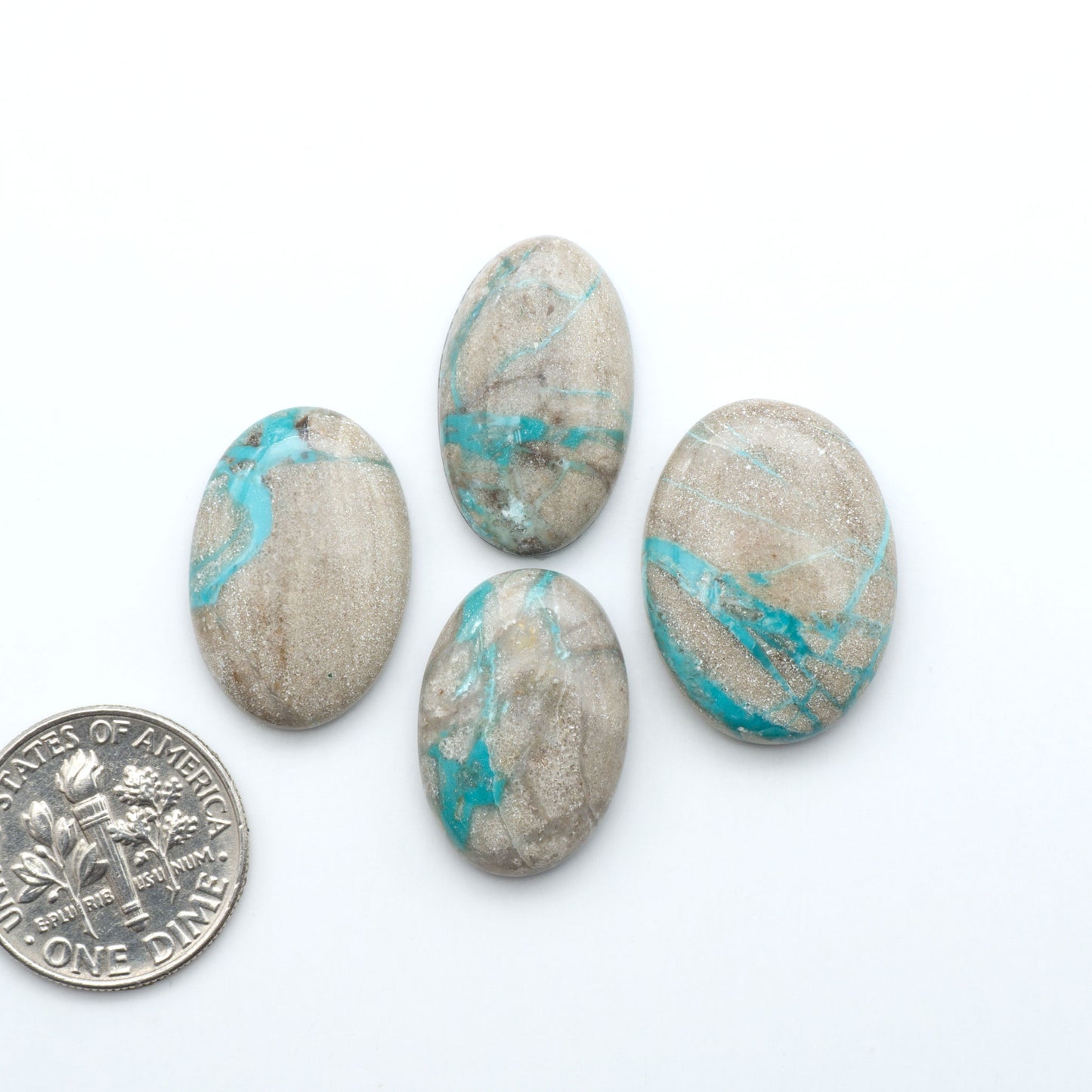 Carico Lake Turquoise cabochons with vibrant aqua-blue to turquoise tones and natural matrix, ideal for rings, pendants, and artisan jewelry.