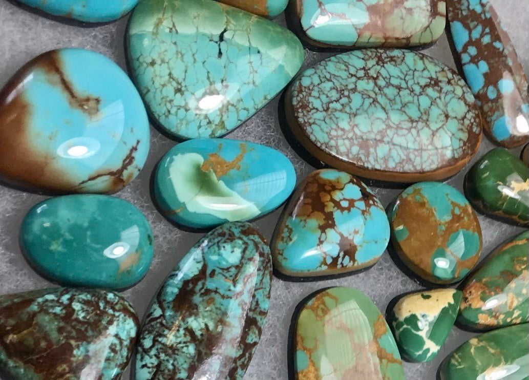 Kings Manassa & Royston Turquoise Cabochons on a white cotton back ground