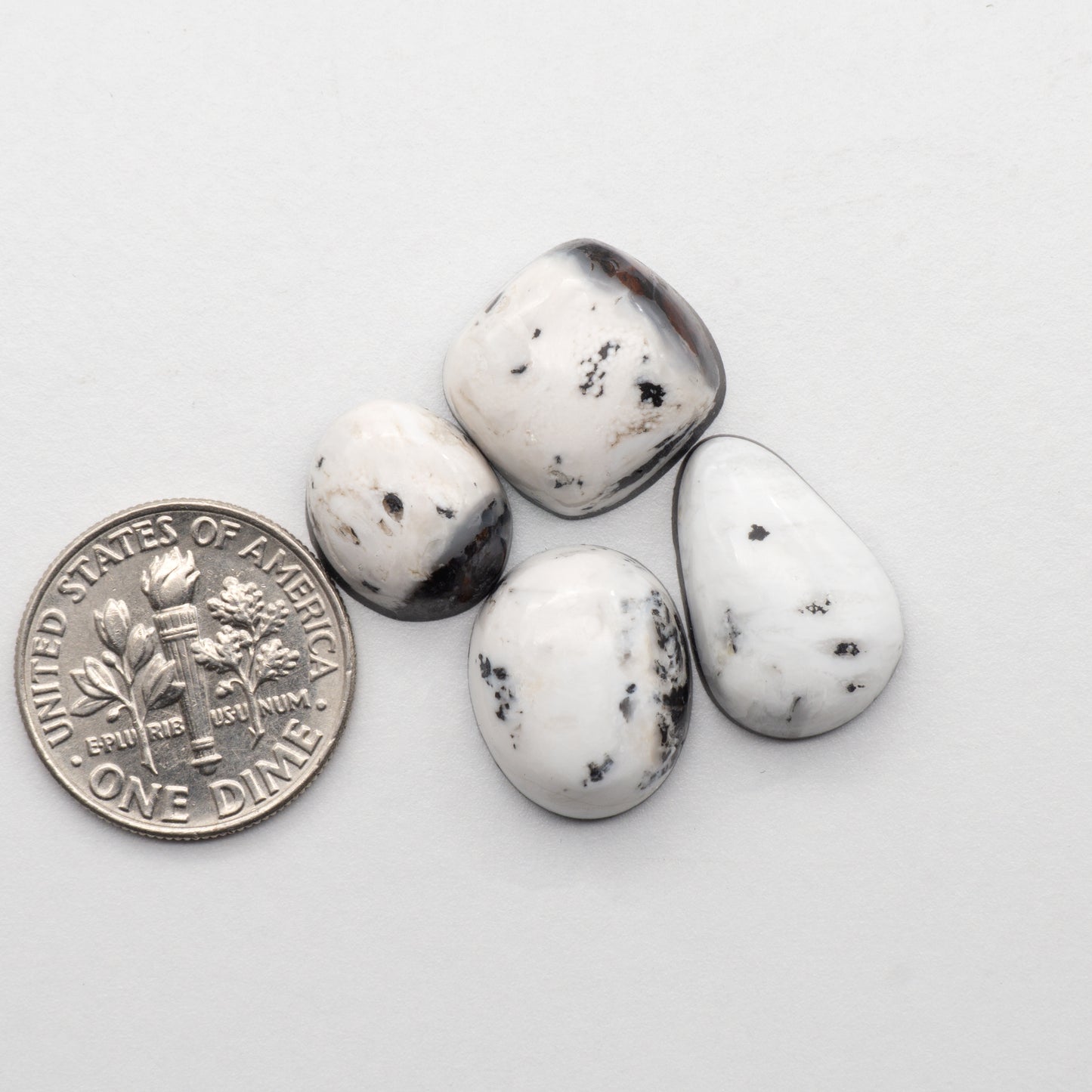 White Buffalo Stone Cabochons are semi-precious gemstones cut into shapes ideal for jewelry-making and crafting. The unique and varied veining of each cabochon lend an unparalleled depth and detail to any project, making them an excellent choice for artisans looking to add an individualistic touch.