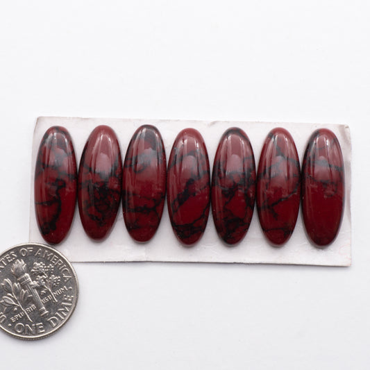 Bloody Bison Jasper is a composite stone  with a vibrant red hue and black matrix 