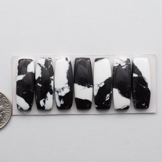 White Buffalo Cabochons are expertly cut and polished from composite material to create a stunning and durable gemstone. These stones measure 8x22mm and are unbacked.