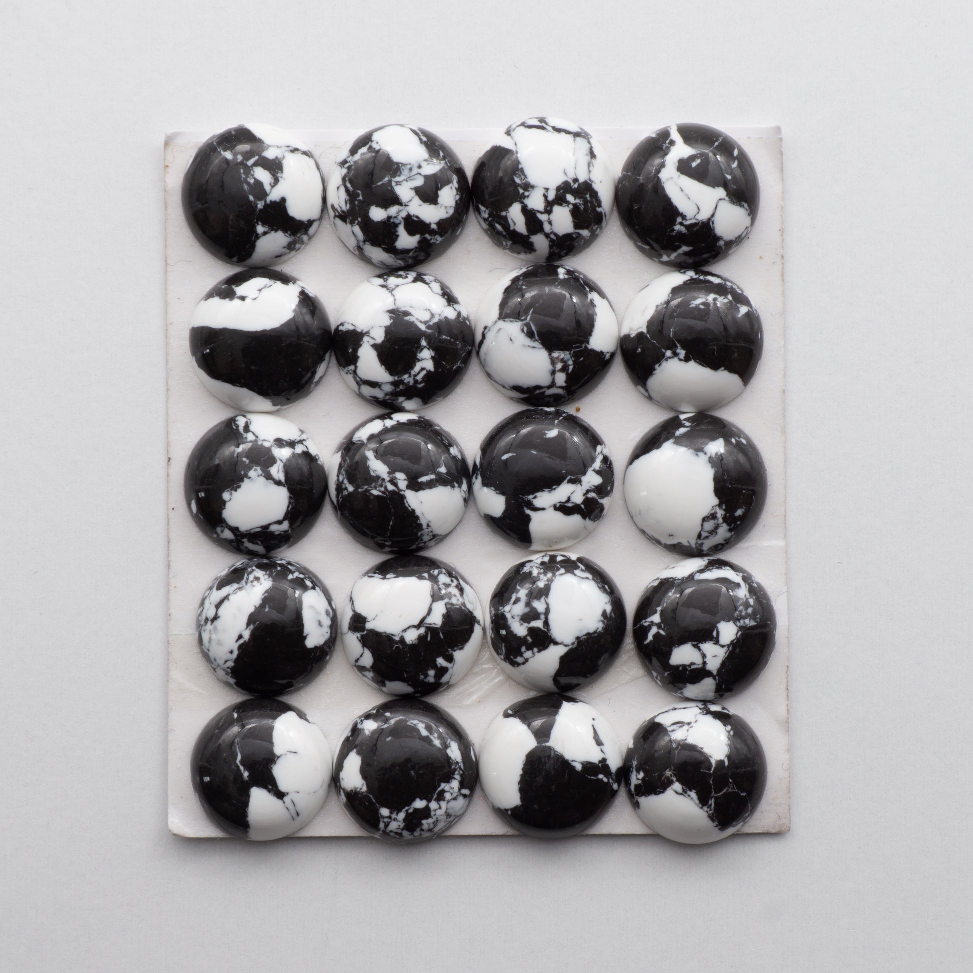 White Buffalo Cabochons are expertly cut and polished from composite material to create a stunning and durable gemstone. These stones measure 12x12mm and are unbacked.