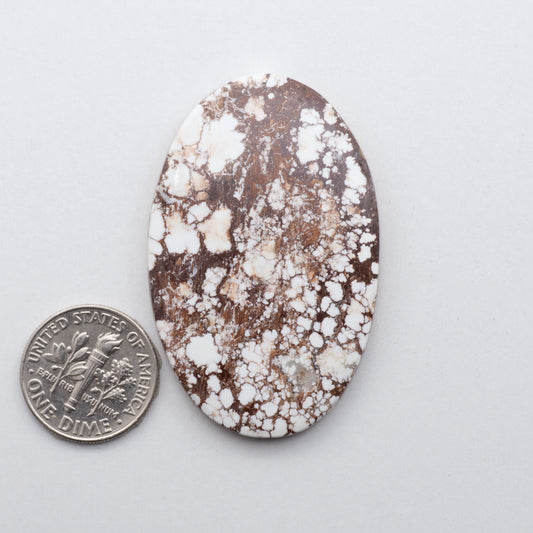 This natural magnesite stone features an intricate design that will instantly add beauty and sophistication to any jewelry design.