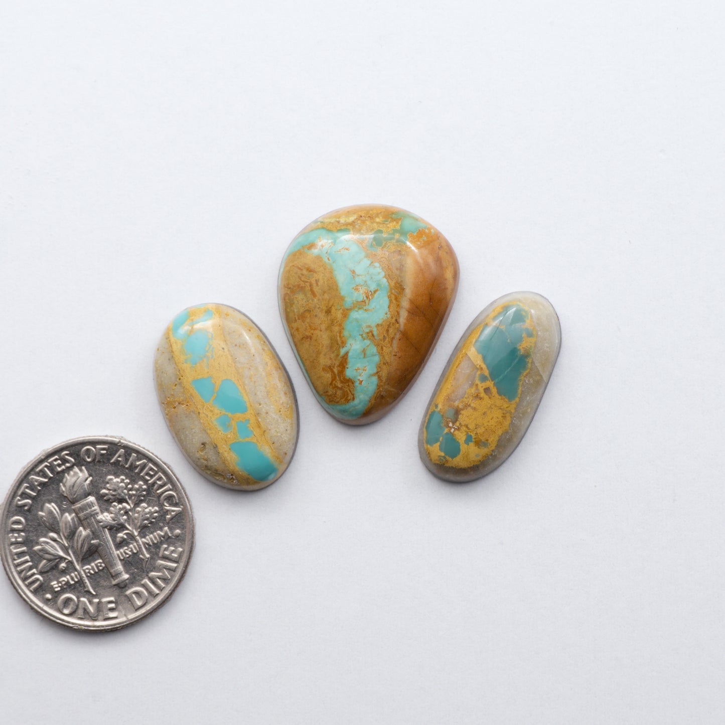 Royston Ribbon Turquoise cabochons are renowned for their unique shades of green, blues, making these cabochons a popular choice for jewelry makers.