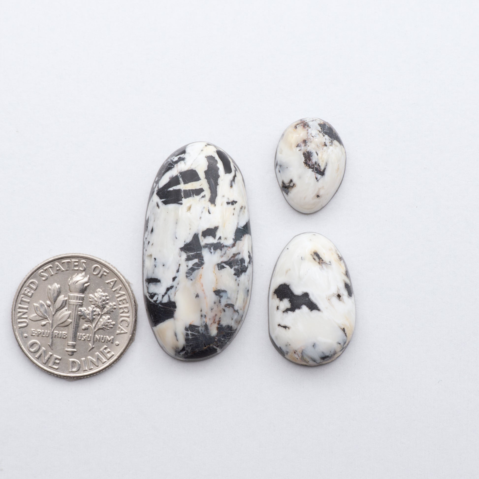 These Natural White Buffalo Stone Cabochons are semi-precious gemstones cut into shapes ideal for jewelry-making 