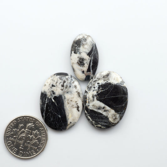 Natural White Buffalo Stone Cabochons are semi-precious gemstones cut into shapes ideal for jewelry-making, making them an excellent choice for artisans.